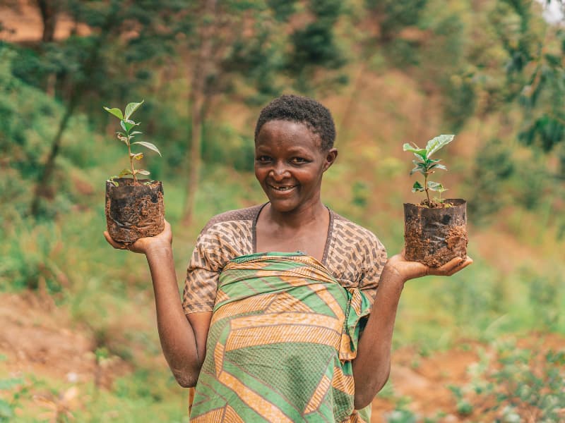 Time to plant- A woman posing with her saplings